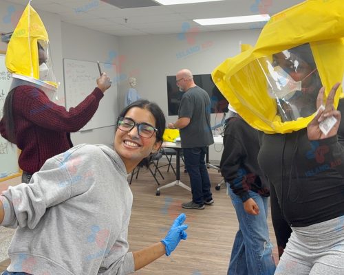 Trainer and students engaging in a fun, interactive first aid session at IslandAid.