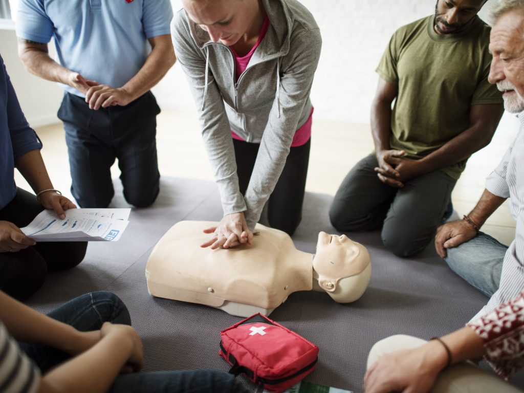 Group of diverse people in cpr training class Emergency First Aid and CPR Level C course for essential life-saving skills.