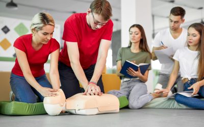 young people learning how to safe a life sitting together on lesson CPR and AED Level C course to learn life-saving skills for emergencies.
